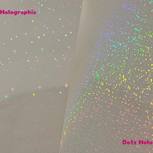 May include: Two sheets of holographic paper, one with a star pattern and the other with a dot pattern. The text "Star's Holographic" is printed on the left sheet and "Dots Holographic" is printed on the right sheet.
