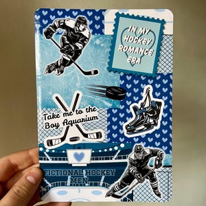 May include: A blue and white hockey-themed sticker sheet with various graphics. Includes images of hockey players, skates, a puck, and text that reads "In My Hockey Romance Era" and "Take me to the Boy Aquarium".
