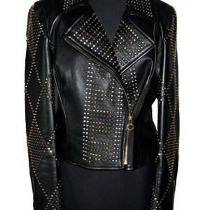 May include: Black leather jacket with gold studs. The jacket has a zip fastening and a collar.
