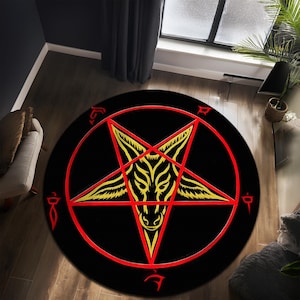 Puede incluir: Una alfombra redonda negra y roja con un pentagrama amarillo y una cabeza de cabra en el centro. El pentagrama tiene cinco puntas y está rodeado por un círculo rojo.