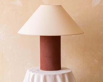 Handmade ceramic table lamp, a lighting and decorative object. Garnet ceramic base and off-white canvas shade.