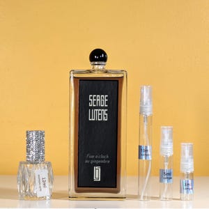May include: A set of perfume bottles, including a large bottle of Serge Lutens Five o'clock au gingembre perfume, a 12 ml sample bottle, a 10 ml sample bottle, a 5 ml sample bottle, and a 3 ml sample bottle.
