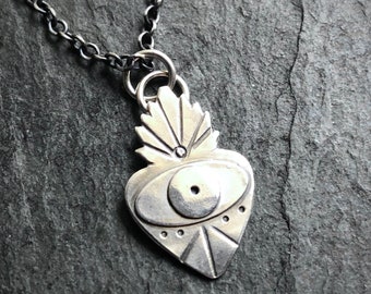 Small sterling silver sacred heart evil eye