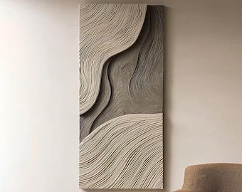 May include: Abstract wall art featuring a textured design with layered, wave-like patterns. The artwork has a neutral color palette of beige and gray, creating a modern and minimalist aesthetic. The rectangular piece is mounted on a wall.