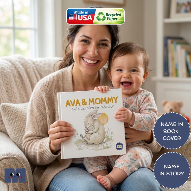 May include: A smiling person and baby hold a book titled "AVA & MOMMY." The book cover features a bunny illustration. The image includes "Made in USA" and "Recycled Paper" labels. The book is personalized.