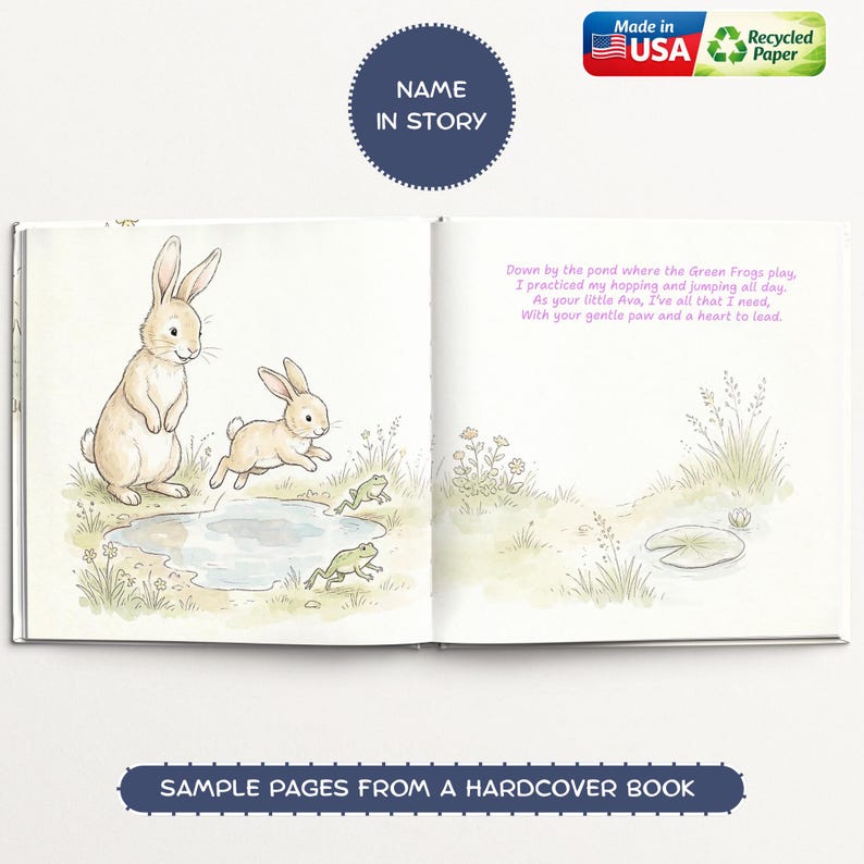 May include: Open book with illustrations of a bunny family near a pond with frogs. The text reads "Name in Story" and "Sample Pages from a Hardcover Book." The book is made in the USA with recycled paper.