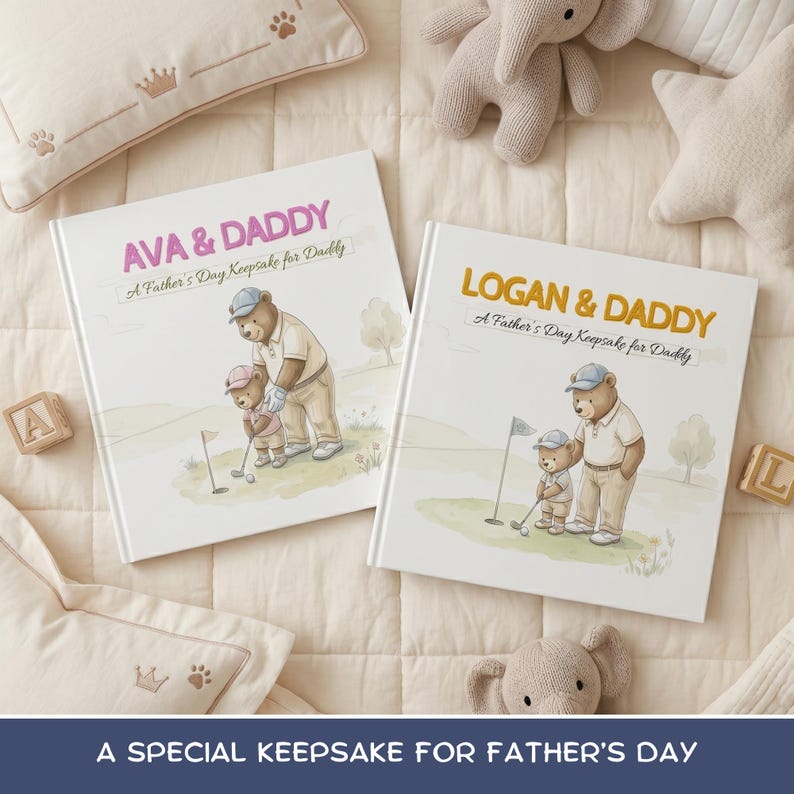 May include: Two hardcover books with illustrations of bears playing golf. The books are titled "AVA & DADDY" and "LOGAN & DADDY", with the text "A Father's Day Keepsake for Daddy". The books are on a cream-colored surface with decorative pillows and stuffed animals.