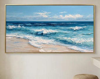 Peut inclure: Une peinture à l'huile rectangulaire dans un cadre doré fin représentant une scène côtière avec une plage de sable, des vagues bleu turquoise et bleu profond avec de l'écume blanche, et un ciel bleu clair avec des nuages blancs épars.