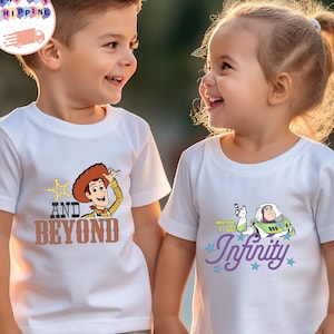 May include: Two children wearing white t-shirts with Toy Story graphics. One shirt features Woody with "AND BEYOND" text, the other has Buzz Lightyear with "TO Infinity" text. Both children are smiling.