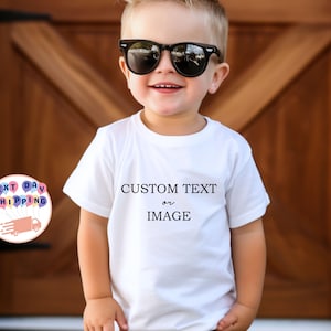 May include: A white t-shirt with the text "CUSTOM TEXT or IMAGE" in black. The child is wearing black sunglasses. The background is a wooden door.