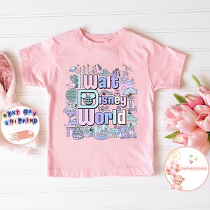 May include: Pink t-shirt with a colorful graphic of Walt Disney World landmarks and the text "Walt Disney World".