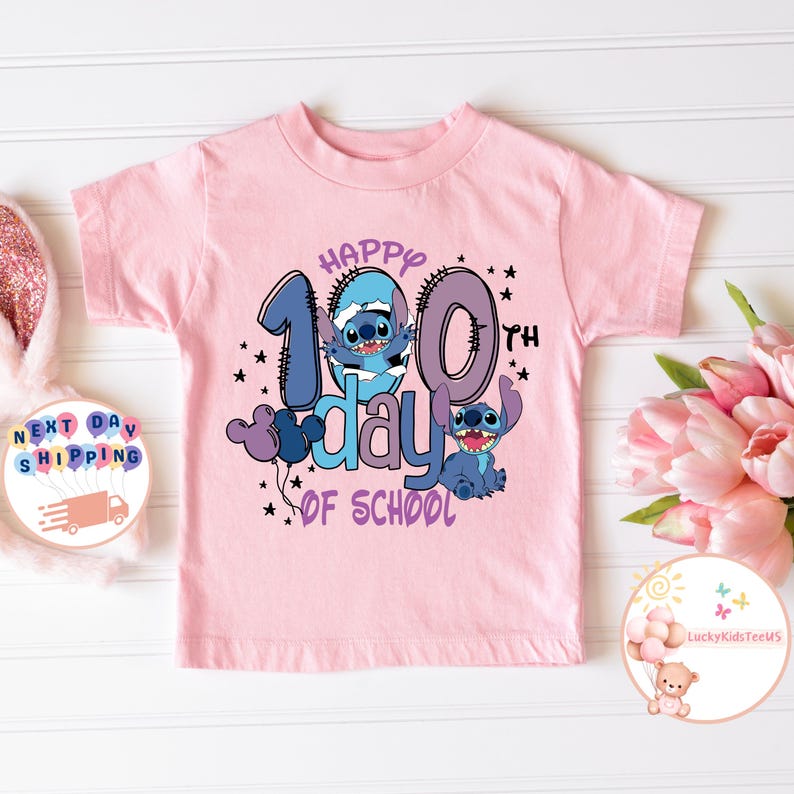 May include: Pink t-shirt with a blue Stitch character and the text "Happy 100th day of school" in purple and blue.