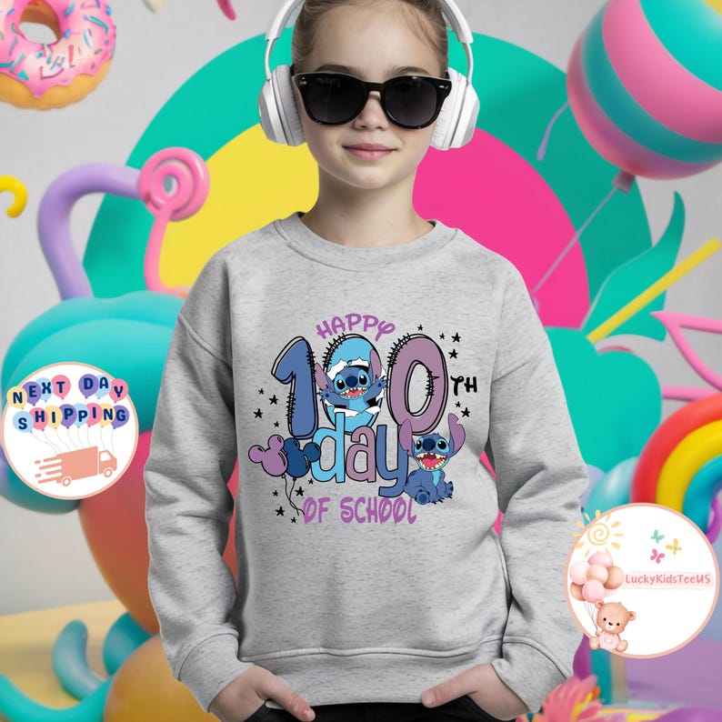 May include: A gray sweatshirt with a blue Stitch character design. The text on the shirt reads "Happy 100th Day of School".