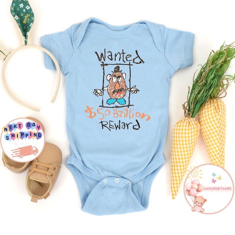 May include: Light blue baby onesie with a cartoon drawing of Mr. Potato Head in a wanted poster. The poster says "Wanted" and "&pound;50 Billion Reward".