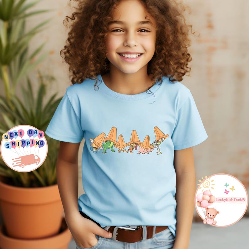 May include: A white ceramic mug with a black handle and the text "But First, Coffee" in a black, handwritten-style font. The mug is on a white surface.