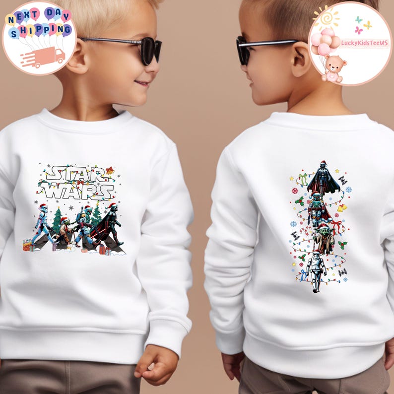 May include: White sweatshirt with a Star Wars design, featuring characters in festive attire. The front shows the Star Wars logo and characters. The back displays characters in a vertical line with Christmas lights and snowflakes.