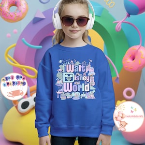 May include: A royal blue sweatshirt with a colorful graphic print of the Walt Disney World logo and various attractions. The text on the graphic reads "Walt Disney World".