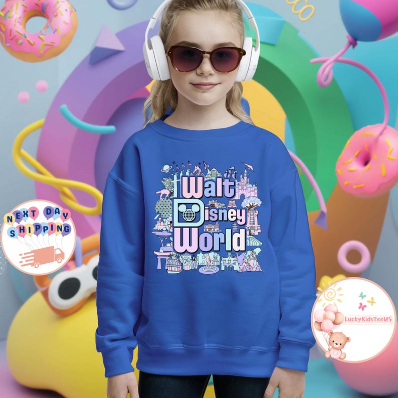 May include: A royal blue sweatshirt with a colorful graphic print of the Walt Disney World logo and various attractions. The text on the graphic reads "Walt Disney World".