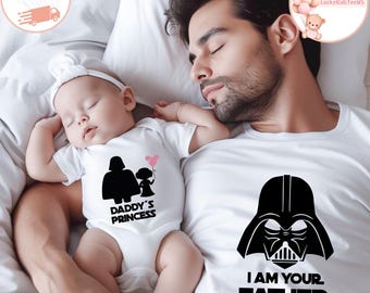 May include: A white onesie with a black graphic of Darth Vader and a child holding a balloon, with the text "DADDY'S PRINCESS". A white t-shirt with a black Darth Vader graphic and the text "I AM YOUR FATHER".