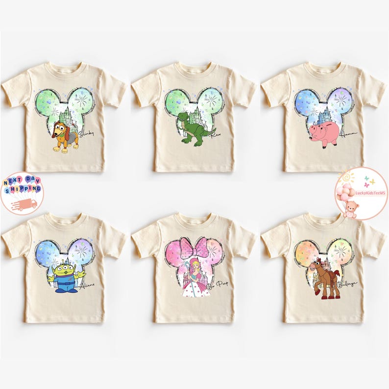 May include: Six cream coloured t-shirts with a Mickey Mouse ear design featuring different Disney characters. The characters include Woody, Rex, Hamm, Bo Peep, Bullseye, and a pig. Each shirt has the character's name printed below the image.