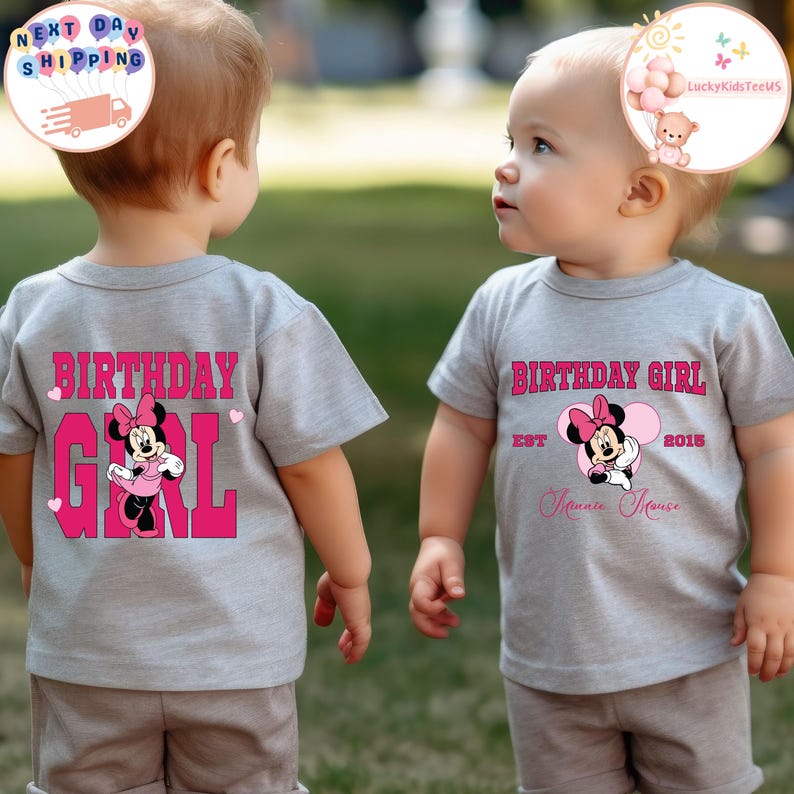 May include: Two children wearing gray t-shirts with a pink Minnie Mouse design. The front of one shirt says "Birthday Girl Est 2015 Minnie Mouse" and the back of the other shirt says "Birthday Girl".