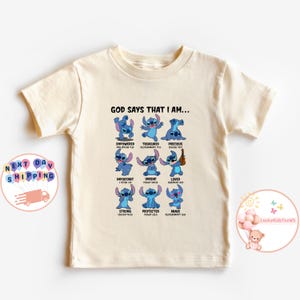 May include: A light beige t-shirt with a blue Stitch character from the Disney movie Lilo & Stitch. The shirt has the text "God says that I am..." with a list of positive affirmations and bible verses.