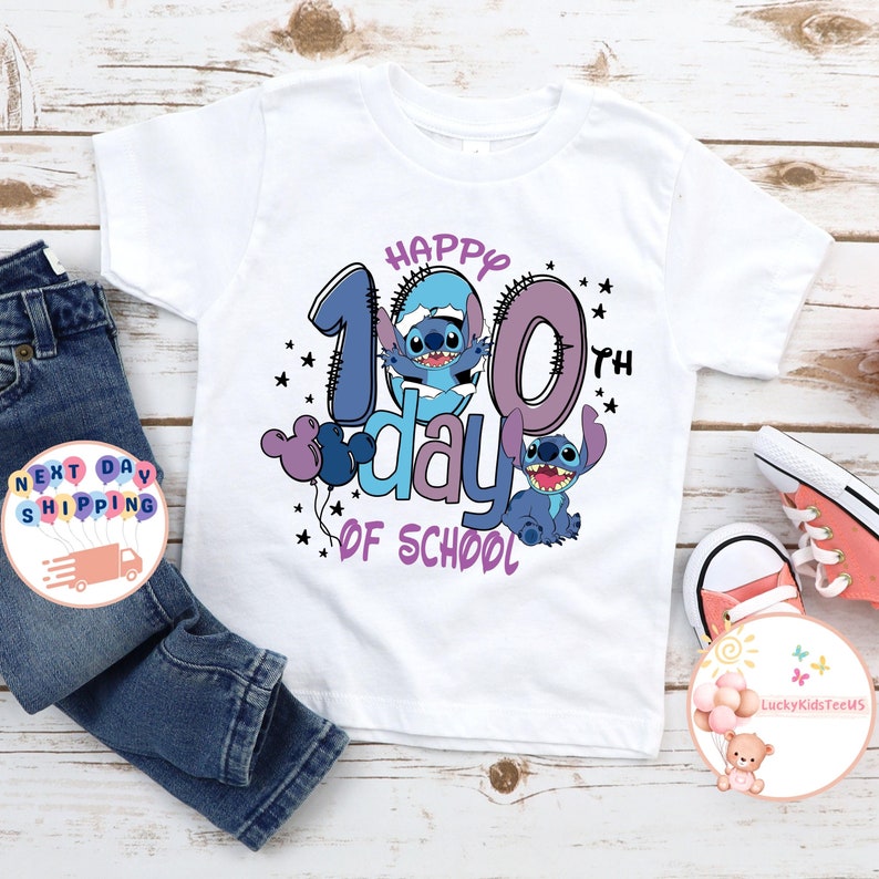May include: White t-shirt with a blue and purple design featuring Stitch from Lilo & Stitch. The design says "Happy 100th day of school".