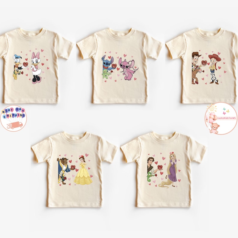 May include: Five cream-colored t-shirts featuring cartoon couples with hearts. Donald Duck and Daisy Duck, Stitch and Angel, Woody and Jessie, Belle and Beast, and Rapunzel and Flynn are depicted. Each design includes red heart accents.