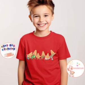 May include: A white ceramic mug with a black handle and the text "But First, Coffee" in a bold, black font. The mug is set against a blurred background, suggesting a cozy setting.