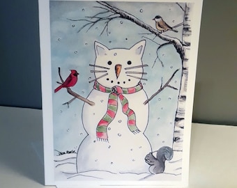 May include: A white cat snowman with a red and green scarf, standing in a snowy landscape with a cardinal and a squirrel. The snowman has a carrot nose and black eyes. The background is a light blue watercolor wash.