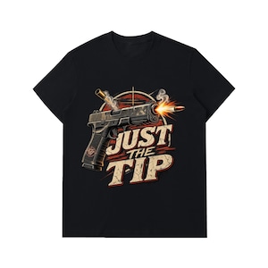 May include: A black short-sleeved t-shirt featuring a graphic of a handgun firing a bullet with smoke and a muzzle flash. The text "JUST THE TIP" is printed in large, distressed beige letters below the firearm, set against a circular red target.