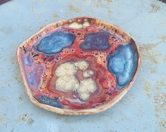plate with sgraffito bottom in reds and blues