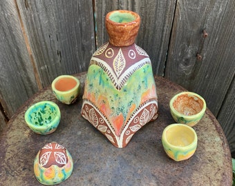 ceramic sake set in bright autumn leaves