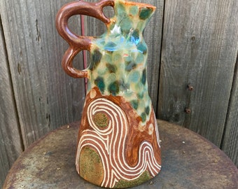 ceramic vase with green polka dots and triple loopy handle