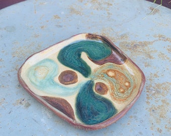 plate with sgraffito bottom in teal and copper
