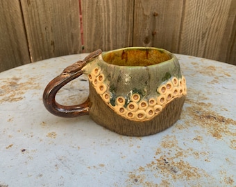 ceramic mug with leafy copper handle