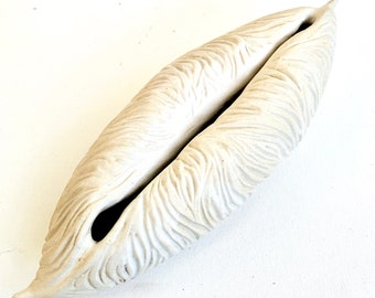 carved white pod sculpture