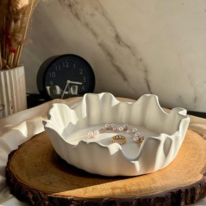 May include: A set of three ceramic mugs with a speckled, matte finish in cream, light grey, and dark grey. Each mug has a minimalist design, ideal for tea or coffee.