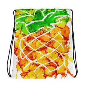 May include: A white drawstring bag with a colorful abstract pineapple design. The pineapple is outlined in white and has yellow, orange, and green hues.