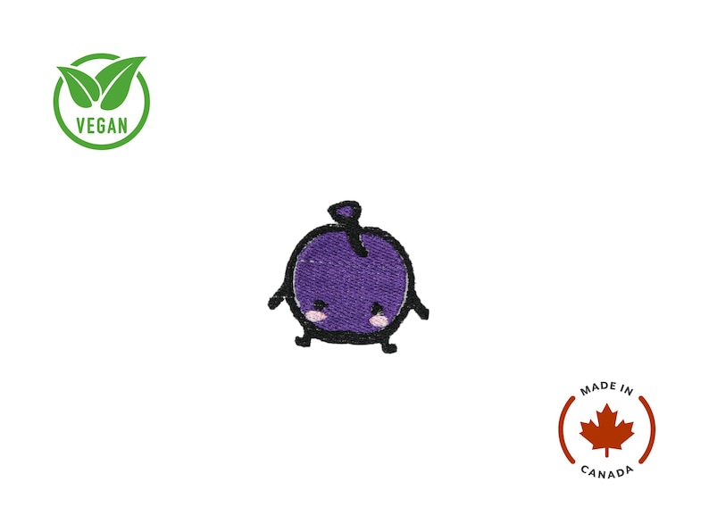 Puede incluir: Parche de fruta morada bordada con una cara linda y contornos negros. El parche tiene un tallo y peque&ntilde;os brazos y piernas. La palabra "VEGAN" est&aacute; en un c&iacute;rculo verde. Hecho en Canad&aacute;.
