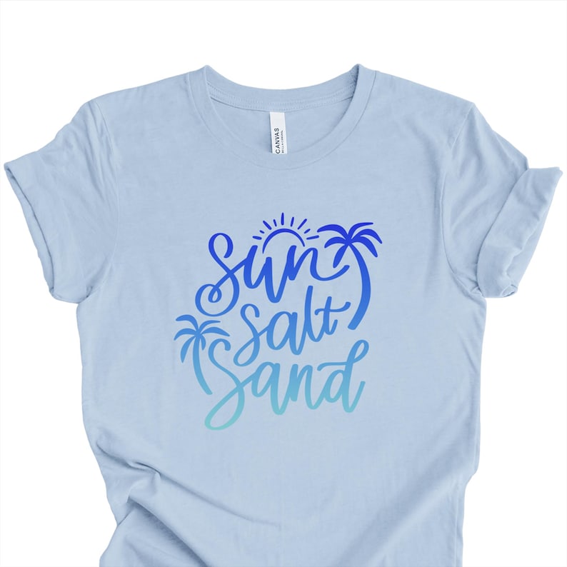 Light Blue summer graphic tee  with medium blue sun salt sand cursive colorful gradient design.