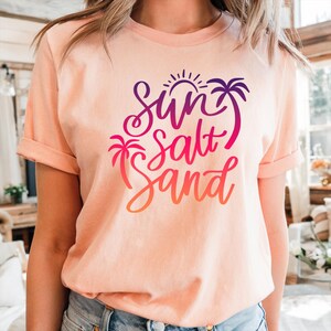 Peach colored sun salt sand tee colorful script in purple, pink and orange, summer beach shirt.