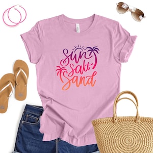 Ocean lover tee in Heather Bubble Gum color with sun salt sand script, makes a beachy vibe top.