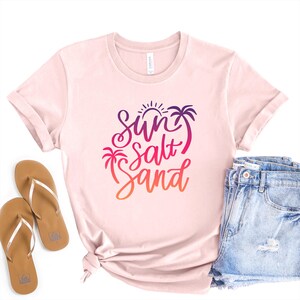 Coastal shirt in Soft Pink with  sun salt sand colorful graphic, makes a fun summer outfit.