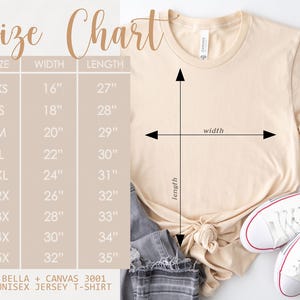 A cream-colored Bella + Canvas 3001 unisex jersey t-shirt with a size chart. The chart lists sizes XS to 5X, with corresponding width and length measurements in inches. A pair of white sneakers with red accents are visible.  Shown with the Sun Salt Sand beach tee listing.