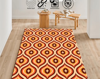 May include: A rectangular rug with a retro design. The rug features a repeating pattern of orange, brown, and cream-colored teardrop shapes with starburst details. The rug is labeled as non-slip, durable, washable, and antibacterial.