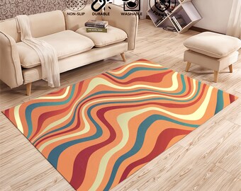 May include: Abstract area rug with wavy lines in shades of orange, red, blue, and cream. The rug is on a hardwood floor.