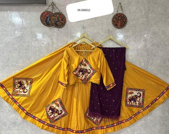 May include: A vibrant yellow traditional Indian outfit, including a top, skirt, and pants. The top and skirt feature embroidered elephant designs. The skirt has a wide, flowing design with a decorative border. The pants are a deep purple color.