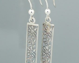 Sterling silver daisy drops on fishhook ear wires.