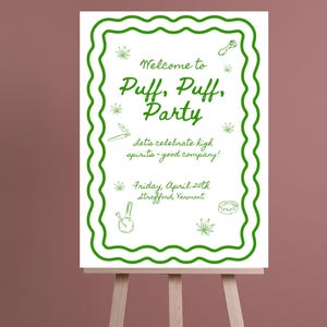 May include: A white sign with a green wavy border and text that reads "Welcome to Puff, Puff, Party." The sign includes cannabis leaf illustrations and the text "Let's celebrate high spirits - good company!" and "Friday, April 20th, Strafford, Vermont."